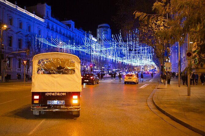 Christmas Lights Tour of Madrid in Eco Tuk Tuk Private - Plaza de Canalejas and the Cortes façade: power buildings lit like a stage