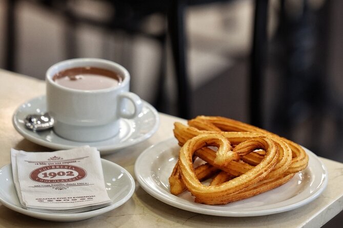 Madrid Bike Tour with Churros and Wine, Ham, and Cheese Upgrade - Plaza de Cibeles: fountains, palaces, and Money Heist trivia