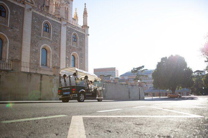 Madrid Express Tour with Local Guide in Eco Tuk Tuk Private - Palacio de las Cortes: lions, iron, and the power of details