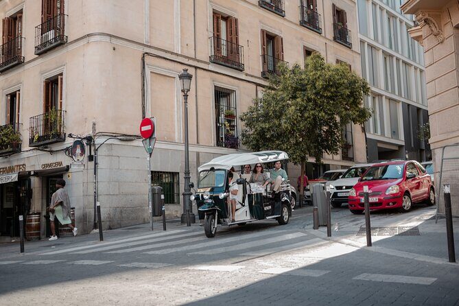 Madrid Historical Tour with Local Guide in Eco Tuk Tuk Private - Puerta de Alcalá, Banco de España surroundings, and Plaza de Santa Ana’s calm