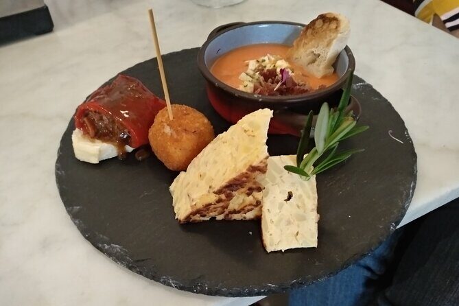 Madrid Small Group Tapas Tour at 4 Venues -Lunch or Dinner - The Old Quarter square and Chocolatería San Ginés: ending with churros, not leftovers