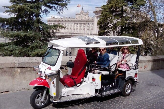 Tour Madrid in 2 hours! Electric Tuk - Fast, Fun, and Exclusive - Plaza de las Cortes, Neptune Fountain, and Puerta de Alcalá: classic facades with hidden clues